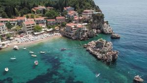 an aerial view of a beach with boats in the water at Kazanegra Exclusive Apartments in Sveti Stefan