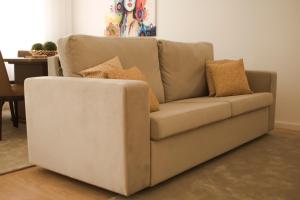 a couch with pillows on it in a living room at Nightingale Apartments in Porto