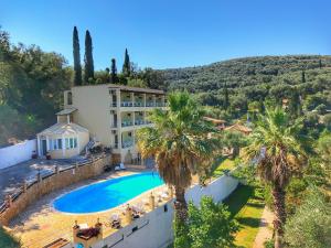 an aerial view of a resort with a swimming pool and palm trees at Avra Sunset Sea View Liapades in Liapades