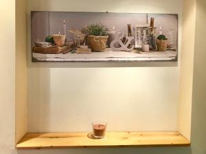 a shelf with plants and a cup on it at Studio Porteille d'Ax entièrement rénové ! in Ax-les-Thermes