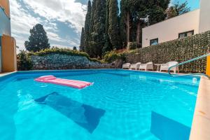 a pool with a pool table and chairs in it at Residence Villa Il Glicine in Taormina