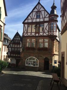 an old building with a clock tower on top of it at Ferienhaus Moselblick mit kostenfreien ÖPNV-Ticket in Ürzig
