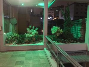 a balcony with a aquarium in a building at Wall Street Flat Service in Caxias do Sul
