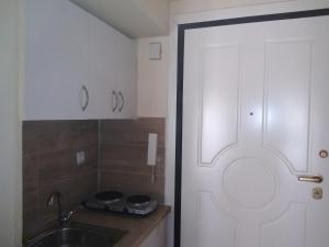 a bathroom with a sink and a white door at Rozy House Nei Epivates Thessaloniki ( Near the sea) in Neoi Epivates +23 photos