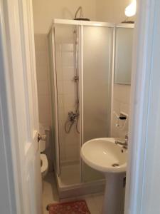 a bathroom with a shower and a sink at Mykonos Beachfront House with Sunset & Delos View in Agios Stefanos +23 photos