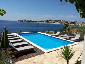 a swimming pool with a view of the water at Villa Sanval in Sevid