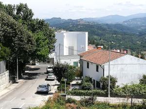 a city street with cars parked in a parking lot at Alojamento de Santa Maria (near Siza Vieira's Church) in Marco de Canavezes +23 photos