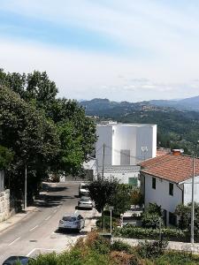 a city street with cars parked in a parking lot at Alojamento de Santa Maria (near Siza Vieira's Church) in Marco de Canavezes