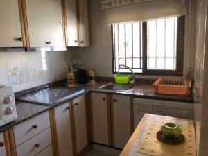 a kitchen with a sink and a counter top at Apartamentos Entreplayas in Oropesa del Mar