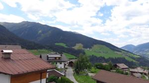 a view of a valley with mountains and houses at Gasthaus Dorfberg in Kartitsch