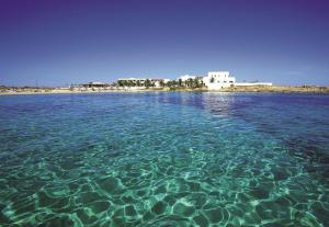 a large body of water with a beach in the background at Hotel Roca Bella in Es Pujols