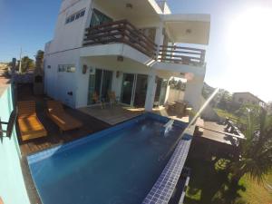 a house with a swimming pool in front of it at Kite'll Out - Casa Flecheiras in Flecheiras