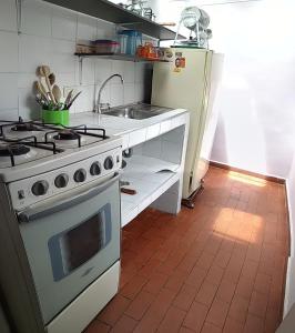 a kitchen with a stove and a refrigerator at Hogar COLONIAL in Bogotá