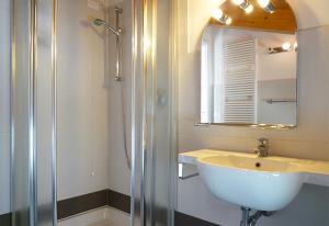 a bathroom with a sink and a shower with a mirror at Residence El Patio in Lido di Jesolo