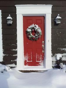 a red door with a christmas wreath on it at Four Ninety Muskoka B & B in Gravenhurst