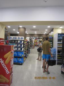 a group of people walking through a store aisle at Villa Helen in Donji Stoliv