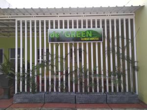 a gate in front of a green office house at de' GREEN Cibubur in Cibubur