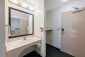 
a bathroom with two sinks and a mirror at Quality Inn & Suites in Clayton
