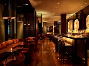 a bar in a restaurant with tables and chairs at Grand Hyatt Melbourne in Melbourne