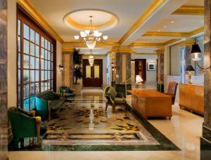 a living room with a lobby with a table and chairs at Grand Hyatt Muscat in Muscat