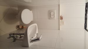 a white bathroom with a sink and a mirror at Apartments Galic Omis in Omiš