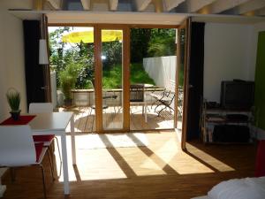 a living room with an open door to a patio at Ferienwohnung Hübschle in Konstanz