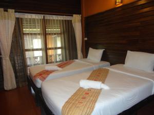Postel nebo postele na pokoji v ubytování Baanfai Guesthouse Chiangkhong