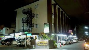 a building with cars parked outside of it at night at Varada Place in Chiang Mai