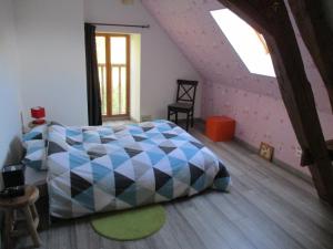 a bedroom with a large bed in a attic at "Le Jardin de Zola", Longère XIXème en BOURGOGNE, grand jardin in Lurcy-le-Bourg