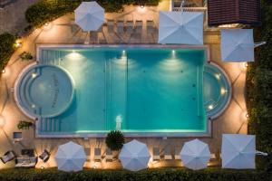 an overhead view of a swimming pool at night at Hotel Villa Tiziana in Marina di Massa