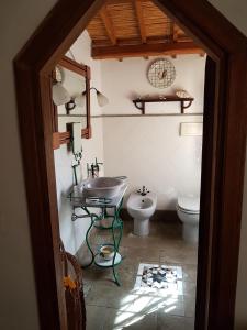 a bathroom with a sink and a toilet at L'AGRUMETO SEGRETO in Riola Sardo