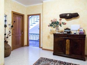 a room with aoyer with a door and a table with flowers at Il Sestante in Civitanova Marche