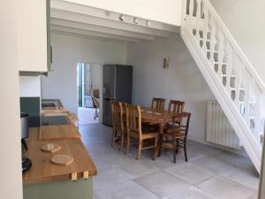 a kitchen and dining room with a table and chairs at Le cœur d'Orques in Saint-Georges-dʼOrques +16 photos