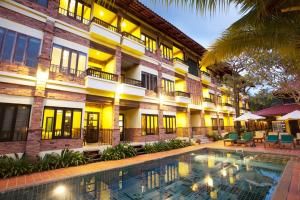 um hotel com piscina em frente a um edifício em Khaolak Tony Lodge em Khao Lak