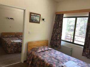 a bedroom with two beds and a window at Health Habitat Hotel & Slimming Resort in Pedoulas
