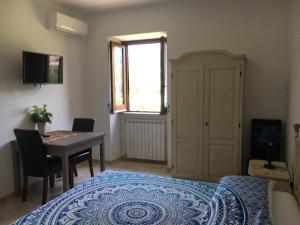 a bedroom with a bed and a table and a window at Maison de Charme Iommella in Sant'Agnello