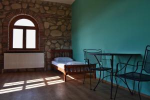a room with a table and chairs and a window at Elizbar Talakvadze Winery in Kardanakhi