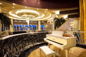 a white piano in a room with a ceiling at Limak Eurasia Luxury Hotel in Istanbul