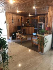a living room with wooden walls and wooden floors at Health Habitat Hotel & Slimming Resort in Pedoulas