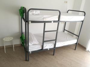A bed or beds in a room at Albergue O Trisquel
