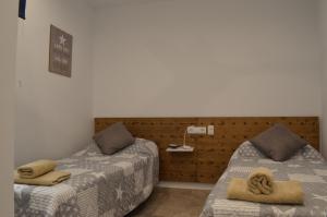 1 dormitorio con 2 camas y toallas. en Arkadia Apartaments 2.2, en Roses