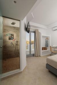 a bathroom with a shower with a glass door at Villa vaya in Naxos Chora