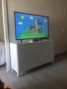 a flat screen tv sitting on top of a entertainment center at Sunny Apartment Puerto Rico in Puerto Rico de Gran Canaria