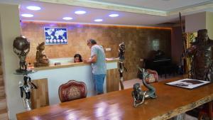 a man standing at a counter in a room with a child at Castle Nolana in Geredeli +53 photos