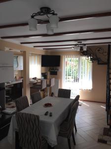 a dining room with a white table and chairs at Casa Roman in Vişeu de Sus