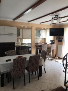 a kitchen and dining room with a table and chairs at Casa Roman in Vişeu de Sus