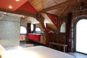 a bathroom with a shower and a bed in a room at Blue House On The Water in Kortrijk