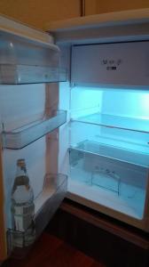 an empty refrigerator with a bottle in it at Ferienwohnung Belle Vue in Bernkastel-Kues