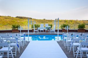 a wedding set up by a pool with white chairs and a table at Limak Eurasia Luxury Hotel in Istanbul