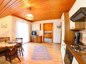 a kitchen and living room with a table and a dining room at Erlebnisbauernhof Urak in Sankt Kanzian +75 photos